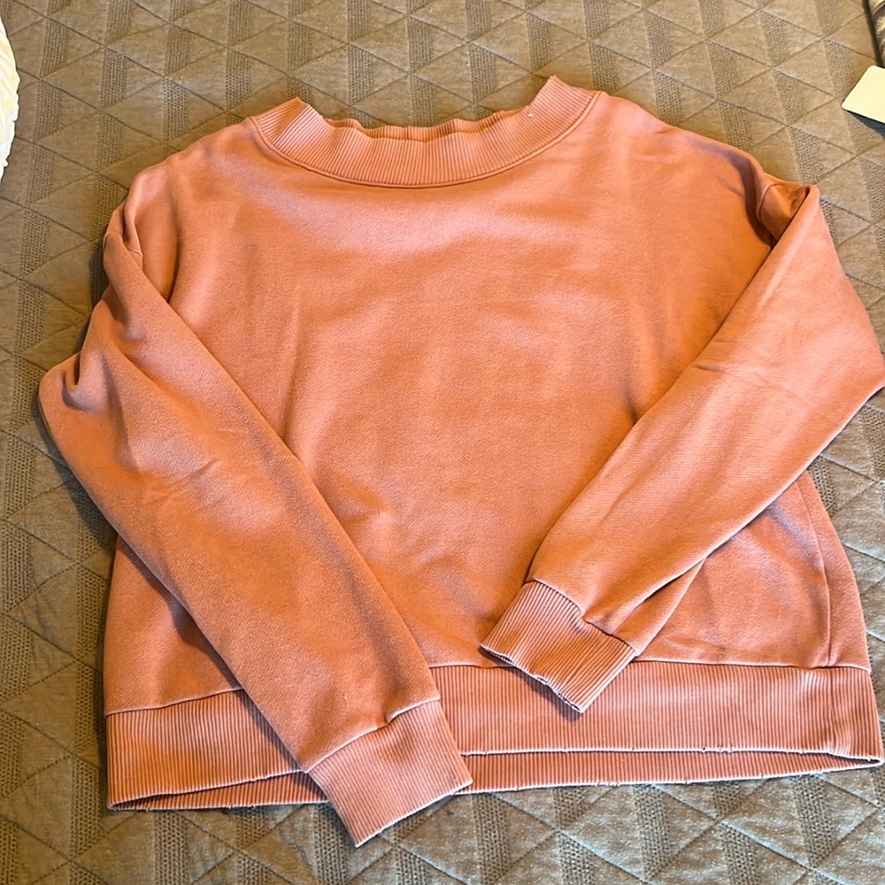pink crew neck, supposed to be distressed.